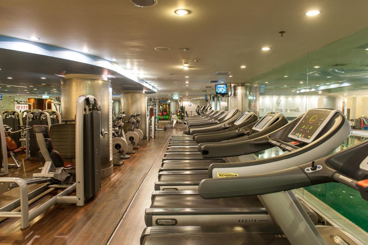 Regent Warsaw Hotel Exterior photo The photo shows the interior of a gym or fitness center. It features a row of treadmills lined up against one wall, with various other exercise machines and equipment visible in the background. The space is well-lit with artificial lighting, and ther